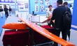 Visitors look at a target aircraft at the 9th China Advanced Materials Industry Expo 2024...