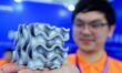 An exhibitor displays a 3D printed aluminum alloy lattice structure at the 9th China Advan...