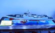 An exhibitor shows a model of a Type 055 destroyer at the 9th China Advanced Materials Ind...
