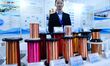 An exhibitor displays enameled wire at the 9th China Advanced Materials Industry Expo 2024...