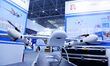 An exhibitor shows a drone at the 9th China Advanced Materials Industry Expo 2024 in Qingd...