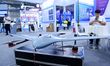 An exhibitor shows a drone at the 9th China Advanced Materials Industry Expo 2024 in Qingd...