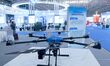 An exhibitor shows a drone at the 9th China Advanced Materials Industry Expo 2024 in Qingd...