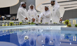 Visitors view models of a new building at the 'Cityscape Qatar 2024' real estate exhibitio...