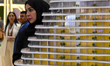Visitors view models of a new building at the 'Cityscape Qatar 2024' real estate exhibitio...