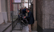 A man tries to squeeze a stroller through an opening in Warsaw, Poland on 12 October, 2024...