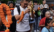 Thais and foreign tourists worship a statue of Lord Brahma, the Hindu god of creation, for...