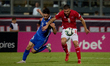 Maxim Cojocaru of Moldova challenges for the ball with Jean Borg of Malta during the UEFA...