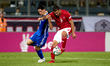 Maxim Cojocaru of Moldova challenges for the ball with Jean Borg of Malta during the UEFA...