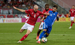 In Ta' Qali, Malta, on October 13, 2024, Gabriel Mentz of Malta vies for the ball with Vit...