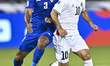 Mahmoud Abuwarda of Palestine battles for the ball with Meshari Alenezi of Kuwait during t...