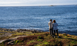 Tourists walk along a scenic pathway near a bridge on the Atlantic Ocean Road in Norway, o...
