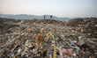 Indian people look for recyclables at a dump site on the eve of World earth day in Guwahat...