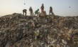 Indian children look for recyclables in a dump site on the eve of world earth day at Guwah...