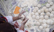 An Iranian nomadic woman works with dough while participating in the 11th National Handicr...