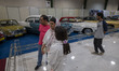 An Iranian family looks at classic cars while visiting the 11th National Handicrafts and 3...