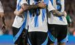 Lionel Messi of Argentina celebrates with his teammates after scoring the fifth goal of hi...
