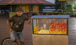 A popcorn vendor stands in the town square at night on the banks of the Amazon River in Af...