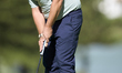 Marcus Armitage of England plays a shot on the 14th green on day one of the Estrella Damm...
