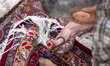 An Iranian worker repairs a Persian handwoven carpet at the Mozaffarieh Carpet Bazaar in t...