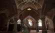 An Iranian woman takes photographs with her cellphone while visiting a mosque in the Tabri...