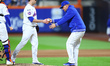 New York Mets manager Carlos Mendoza #64 removes relief pitcher Phil Maton #88 during the...