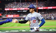Los Angeles Dodgers' Shohei Ohtani #17 is congratulated after scoring during the third inn...