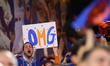 Fans hold up a sign during Game 5 of a baseball NL Division Series between the Los Angeles...