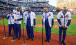 The Temptations sing the National Anthem on the field before Game 5 of a baseball NL Champ...