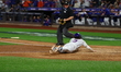 Jesse Winker #3 of the New York Mets scores on a sacrifice fly during the sixth inning in...