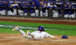 Jesse Winker #3 of the New York Mets scores on a sacrifice fly during the sixth inning in...