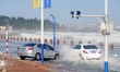 Cars pass a road covered with seawater at the seaside in Yantai, China, on October 19, 202...