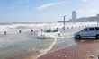 Cars pass a road covered with seawater at the seaside in Yantai, China, on October 19, 202...