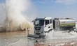 Cars pass a road covered with seawater at the seaside in Yantai, China, on October 19, 202...