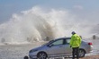 Big waves hit vehicles at the seaside in Yantai, China, on October 19, 2024. 