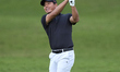 Ashun Wu of China plays his second shot on the 1st hole on the third day of the Estrella D...