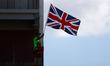 A fan waves the Union Jack during a sprint race at Circuit of the Americas in Austin, Texa...