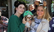 A dog is held up by two women watching the 34th Annual Tompkins Square Halloween Dog Parad...
