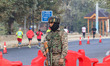 An Indian paramilitary soldier stands alert during the Kashmir Marathon in Srinagar, Jammu...