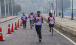 Participants run during the Kashmir Marathon on the banks of Dal Lake in Srinagar, Jammu a...