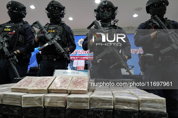 Thai Narcotics Suppression police officers stand guard next to 154 kilograms of heroin confiscated and hidden in their van to be smuggled fr... by Anusak Laowilas/NurPhoto