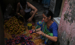 People color diyas (earthen lamps) at Kumbharwada potter's colony of Dharavi slum in prepa...