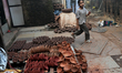 A child walks past diyas (earthen lamps) at Kumbharwada potter's colony of Dharavi slum in...