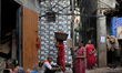 A woman carries earthen diyas on her head at Kumbharwada potter's colony of Dharavi slum i...