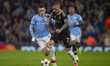 Lukas Haraslin #22 of AC Sparta Praha is tackled by Phil Foden #47 of Manchester City F.C....