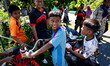 Kids on a motorbike greet the media visiting their village for the first time. Special For...