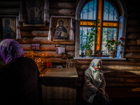 People in a holy mass in the church of Slavutich, Ukraine, city of the relocated workers after the accident of the Chernobyl nuclear plant,...