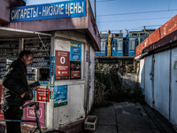 A man buys cigarettes before taking the train in Slavutich, Ukraine,  for the workers in the Chernobyl nuclear plant crossing Belarus, on Au...