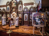 Holy mass in the church of Slavutich, Ukraine, city of the relocated workers after the accident of the Chernobyl nuclear plant. In forefront...
