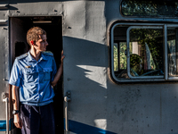 Security officer checks the train for workers in the Chernobyl nuclear plant before the departure from Slavutich crossing Belarus, on August...